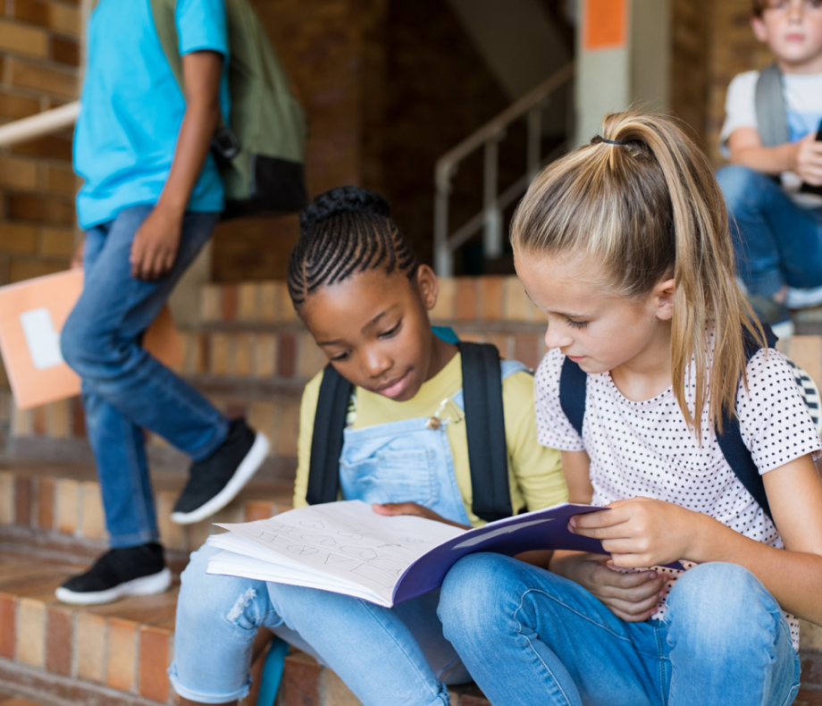 Two Girls Reading on Steps